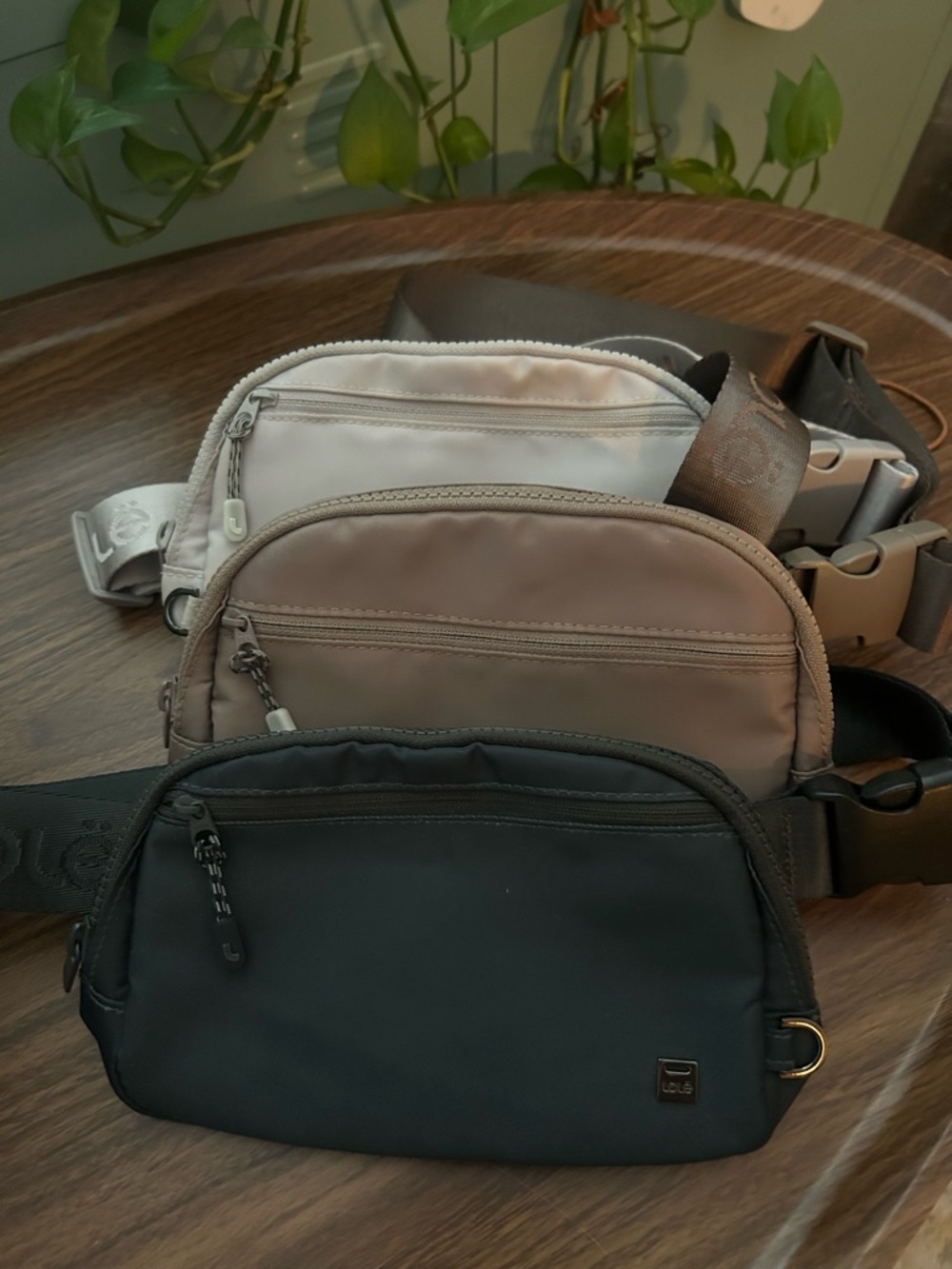 Trio of Lolë Jayme bags: dark Green, champagne and creme